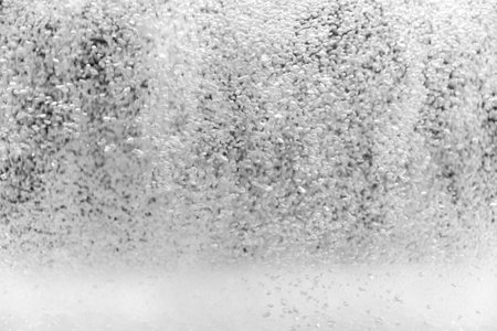 Small water bubbles on a black background. Comming from below in an aquarium.の写真素材