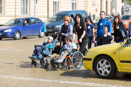 Sofia, Bulgaria - April 6, 2016: Physically and mentally disabled are accompanied by their parents, relatives and friends at a protest against policies against them.のeditorial素材