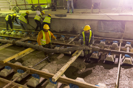 Sofia, Bulgaria - April 19, 2016: Underground subway tunnel workers are pouring concrete at the...