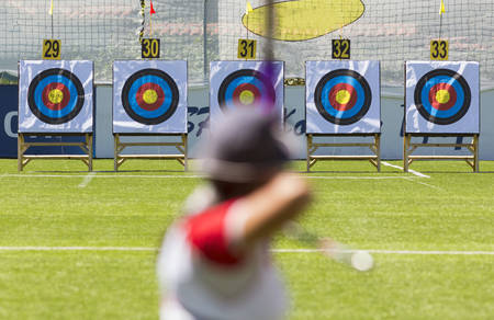 A person is shooting with recurve bow on a target during an archery competition. Focus on the targets.の写真素材