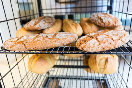 Gluten free bread loafs. Made with leaven and spelt. Gluten-free food. Shown on a black table in a small family bakery.の写真素材