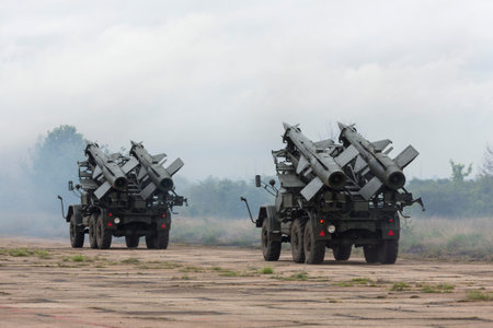 Two mobile antiaircraft missile complexes on trucks, ballistic launcher with missiles ready to...