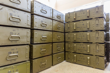 Green ammunition boxes with rocket-propelled grenades (RPGs) in a munition producing factory. Highly dangerous explosives. Ready for shipping in green closed military boxes.のeditorial素材
