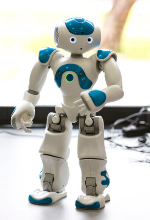A small robot with human face and body - humanoid. Artificial Intelligence - AI. Blue robot.