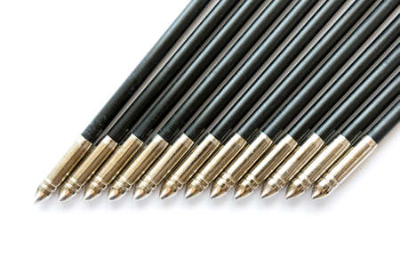 The spikes of a dozen (12) black arrows isolated on a white background.の写真素材