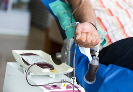 Volunteers are donating blood at the World Blood Donor Day (WBDD). The event serves to raise awareness of the need for safe blood and blood products, and to thank blood donors for their voluntary, life-saving gifts of blood.のeditorial素材