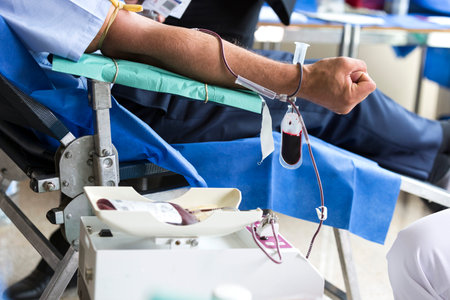 Volunteers are donating blood at the World Blood Donor Day (WBDD). The event serves to raise awareness of the need for safe blood and blood products, and to thank blood donors for their voluntary, life-saving gifts of blood.のeditorial素材