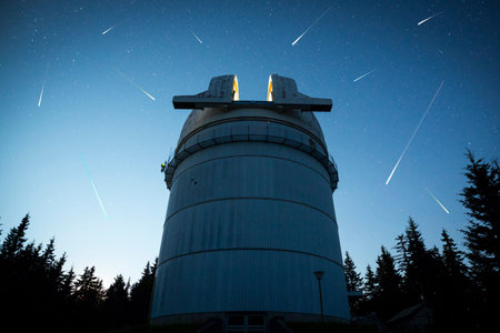 Rozhen astronomical observatory under the night sky stars. Blue sky with hundreds of stars of the Milky way. Bulgarian National Astronomical Observatory (Rozhen Observatory). Meteor shower. Falling stars.のeditorial素材