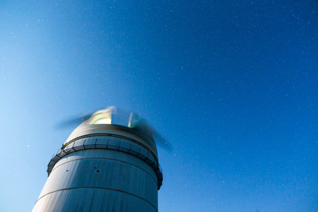 Rozhen astronomical observatory under the night sky stars. Blue sky with hundreds of stars of the...