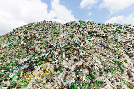 Glass waste for recycling in a recycling facility. Different glass packaging bottle waste. Glass...