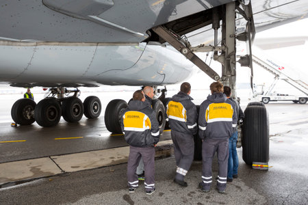 Sofia, Bulgaria - October 16, 2016: Lufthansa Airbus A380 airplane at Sofia's airport. Airport workers in front of the airplane's tires.のeditorial素材