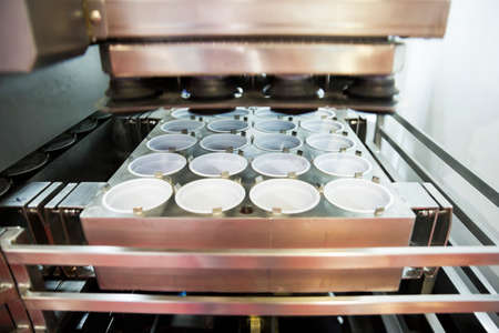 Yoghurt packing machine is shown at a food and drink exhibition. の写真素材