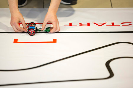 Sofia, Bulgaria - December 17, 2016: A student prepares his race robot during an open competition of...