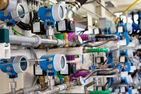 Pipes, cables and indicators of a big modern industrial subway drilling machine. Modern safety technology measuring the oil pressure, electricity circuit flow and others critical processes.の写真素材