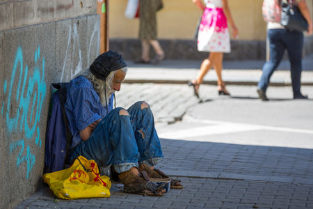Sofia, Bulgaria - 9 July, 2017: Homeless old man with long white beard begs for money at the street....