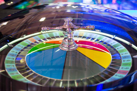 Modern roulette table in casino. Ball in the rotating gambling machine. Colourful roulette wheel.