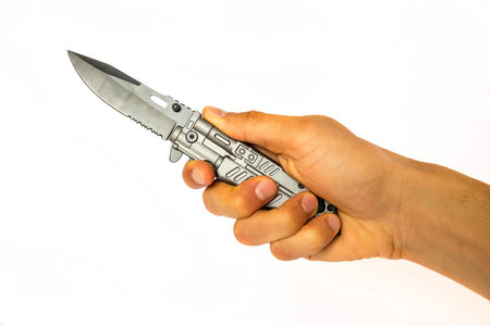 Knife isolated on a white background. Hold by a human hand. Studio shotの写真素材