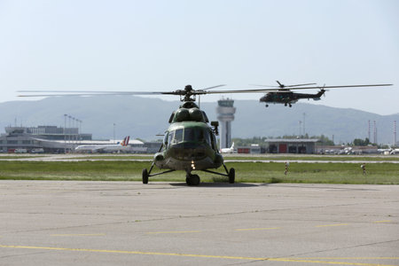 Military helicopters at the runway of the airport.