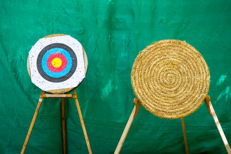 Two different archery target rings during an archery competition. Green background.の写真素材
