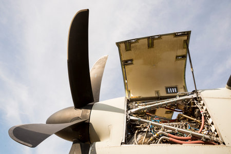 Aircraft engine maintenance. Airplane engine with propeller gets a repair. Military jet.