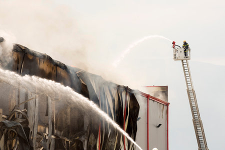 Fire disaster in a warehouse. Fire fighting in an industrial area.