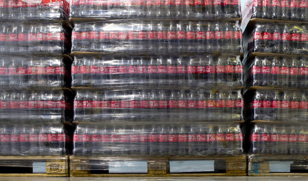 Sofia, Bulgaria - 19 December 2018: Packed Coca Cola bottles in plastic foil on pallets in a...