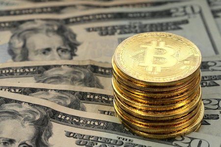 Virtual cryptocurrency money Bitcoin golden coins on United States US twenty dollar bill ($20) with...