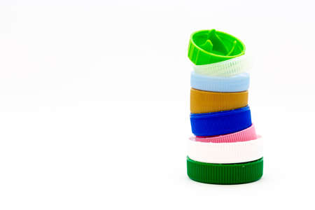 Colorful plastic bottle caps. Studio shot. Plastic waste. Isolated on a white background.の写真素材