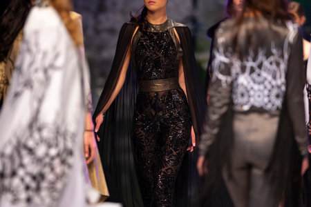 Female models walk the runway in different dresses during a Fashion Show. Fashion catwalk event...