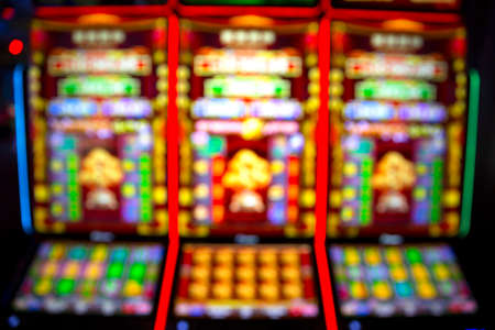 Out of focus blurry image of casino equipment. Blurred slot machines in a casino.の写真素材