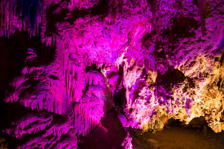 Venetsa Cave in Bulgaria. Beautiful colorful and illuminated cave full with semiprecious onyx stones. Flowstones, stalactites and stalagmites lighted in different vivid colours.の写真素材