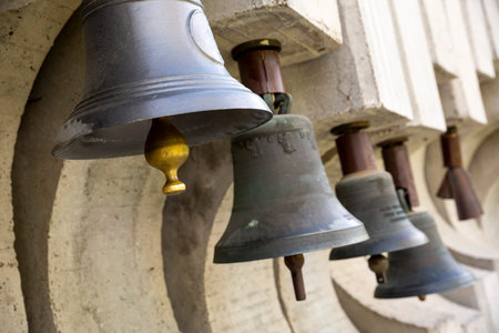 Many old bells - campanes are seen in a row.