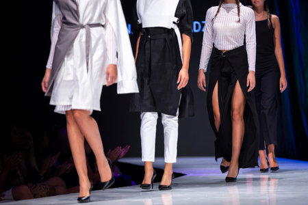 Female models walk the runway in different dresses during a Fashion Show. Fashion catwalk event...