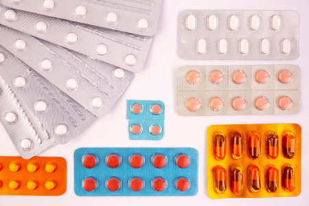 White pills in silver plastic packs - blisters. Global pharmaceutical industry for billions dollars...