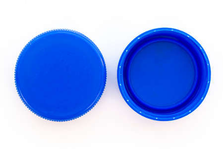 Blue plastic bottle caps. Studio shot. Plastic waste. Isolated on a white background.の写真素材