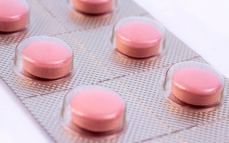 Pink pills in silver plastic pack - blister. Global pharmaceutical industry for billions dollars per...