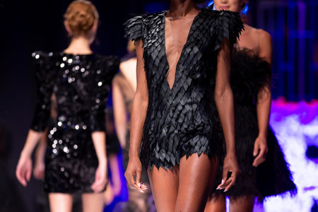 Female models walk the runway in different black dresses during a Fashion Show. Fashion catwalk...