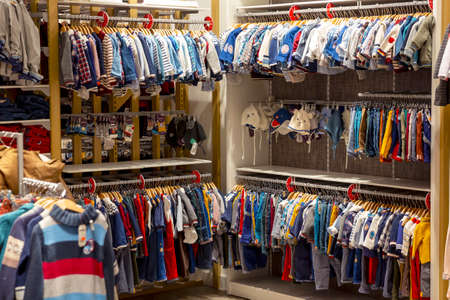 Colorful clothes and accessories hanging in children wardrobe.の写真素材