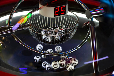 Black and white lottery balls in a rotating bingo machine. Lottery balls in a sphere in motion....