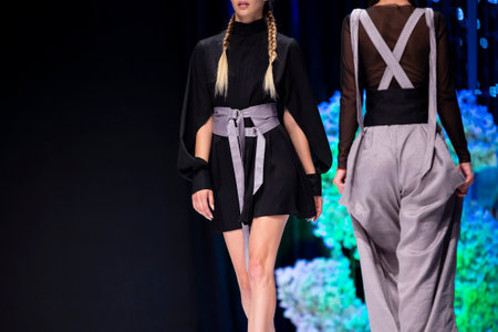 Female models walk the runway in different dresses during a Fashion Show. Fashion catwalk event showing new collection of clothes.のeditorial素材