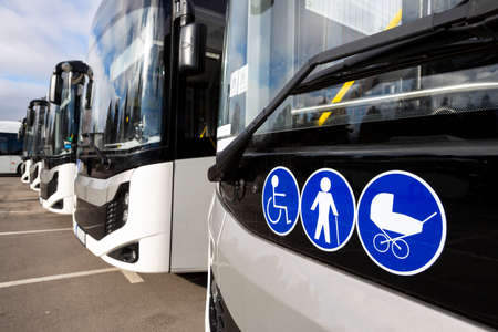 New modern busses on LPG. International Symbol of Access - Wheelchair Symbol (handicapped, physically challenged and disabled), Baby Stroller Symbol and Elderly (Old) People Symbol on the windshield.の写真素材