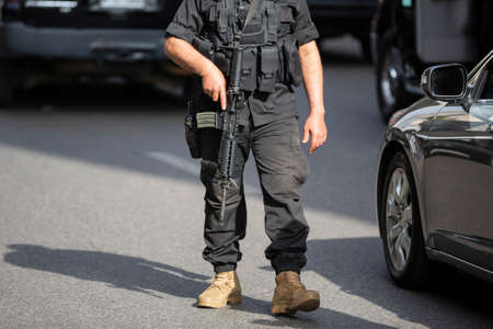 Armed Lebanese soldier in balck uniform patrols a street of Beirut during daytime.の写真素材