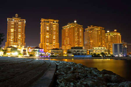 The skyline panorama of The Pearl-Qatar area buildings in Doha, Qatar at night. The Pearl-Qatar is an artificial island spanning nearly four square kilometers. Long exposure.の写真素材