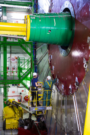 CERN, France - 25 June, 2019: Workers repair part of The Large Hadron Collider (LHC) is seen...