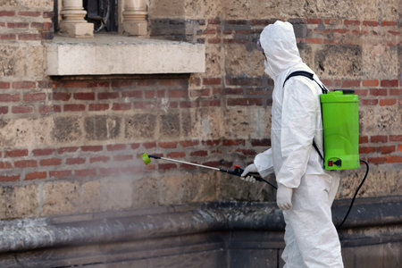 Worker sprays disinfectant outside Sveti Sedmochislenitsi (Seven Saints) church against the spread of coronavirus disease COVID-19.のeditorial素材