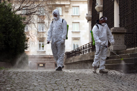 Sofia, Bulgaria - 11 April, 2020: Workers spray disinfectant outside of Sveta Nedelya Church against the spread of coronavirus disease COVID-19.のeditorial素材