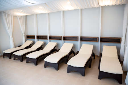 Deck chairs in a row for a relaxation in a spa center.の写真素材