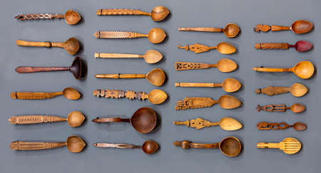 Different carved wooden spoons are seen from above arranged.の写真素材