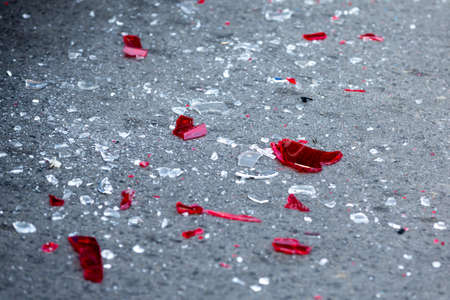 Headlight fragments are seen on the ground in a car crash aftermath.の写真素材