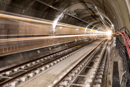 Subway tunnel rail tracks. Long exposure. Blurred lights.の写真素材